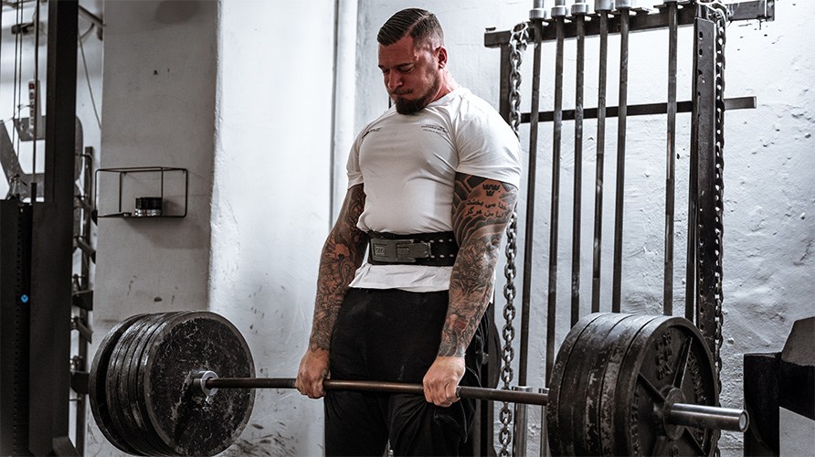 En man utfr trningsvningen marklyft.