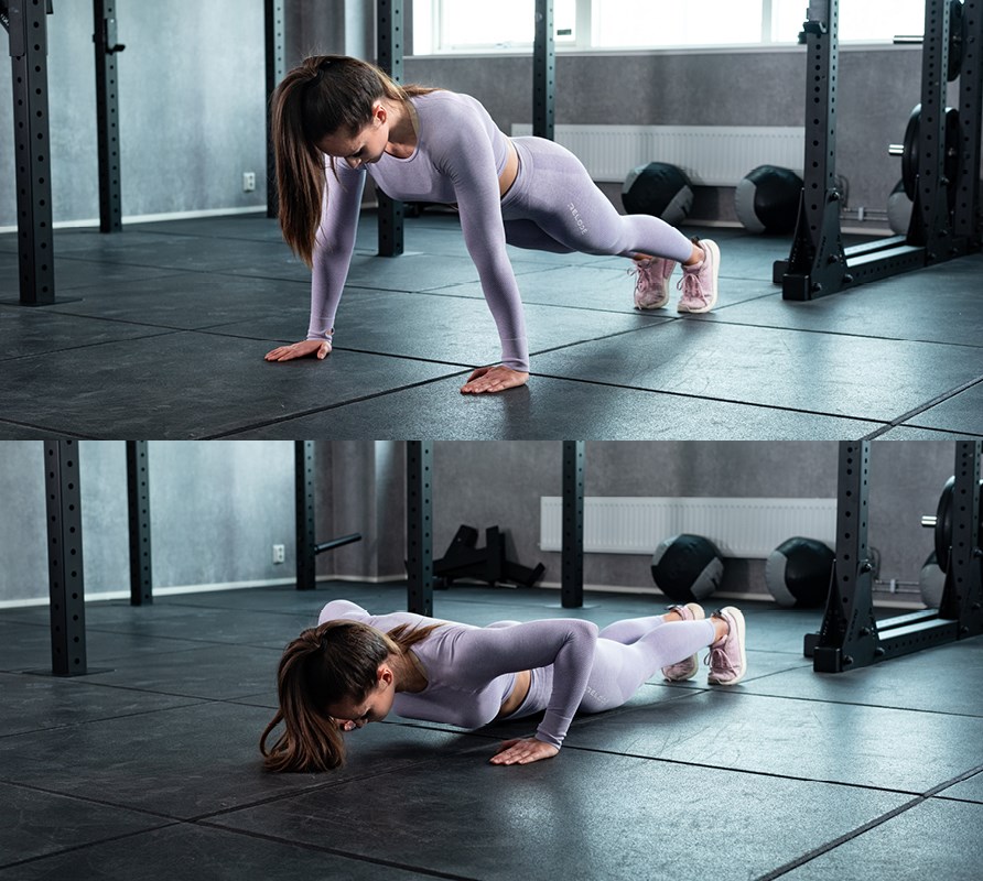 Tjej på gym som visar hur man utför övningen armhävningar Tjej på gym som visar hur man utför övningen armhävningar