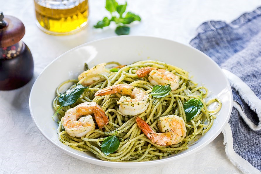 Bild p� pasta med r�kor och pesto i en vit och djup tallrik.